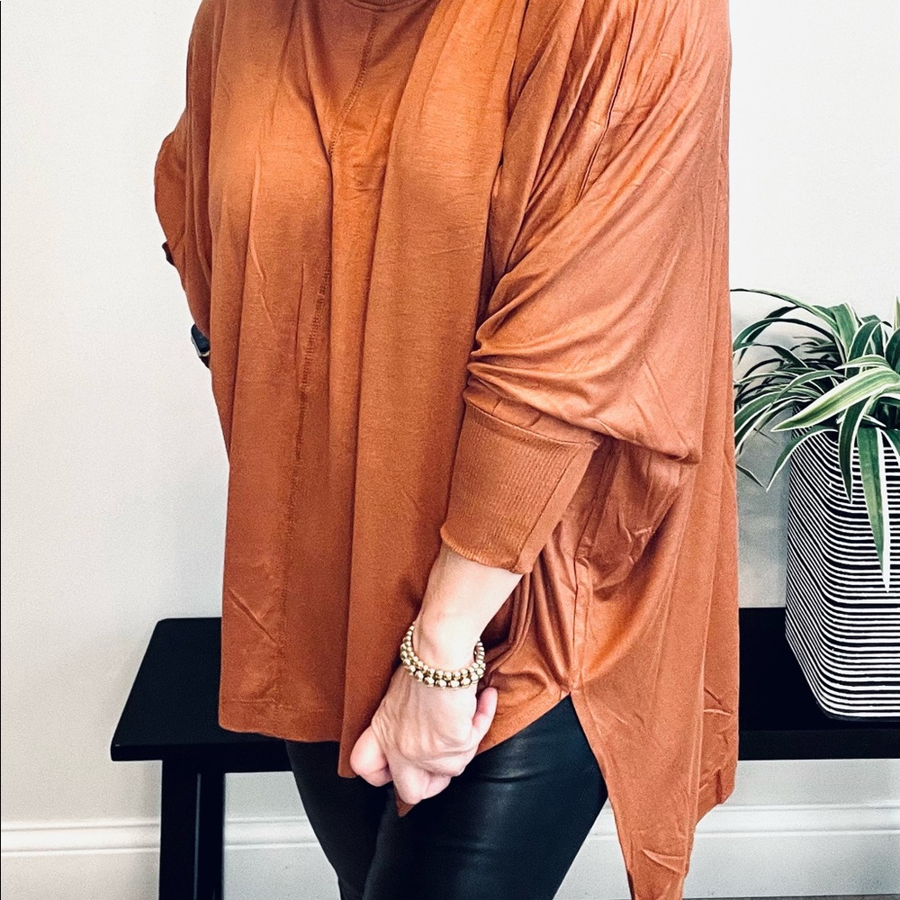 Oversized shark bite dolman top in orange rust
